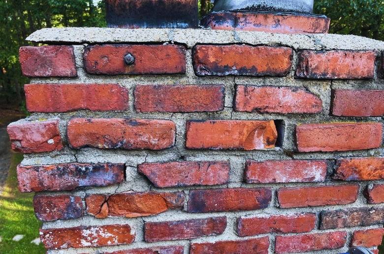 A chimney with cracked mortars and bricks.