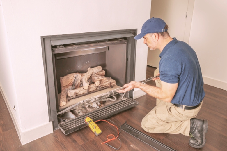 A professional installing am electric fireplace insert.