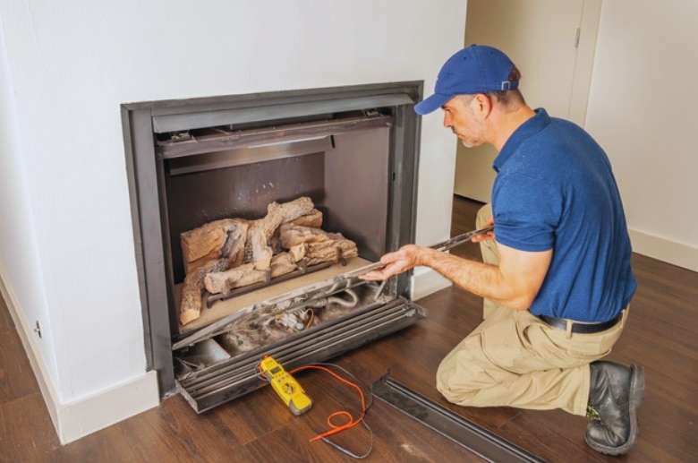 A technician installing a basement fireplace.