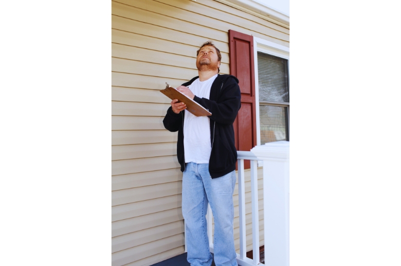 A man checking off the chimney inspection checklist.