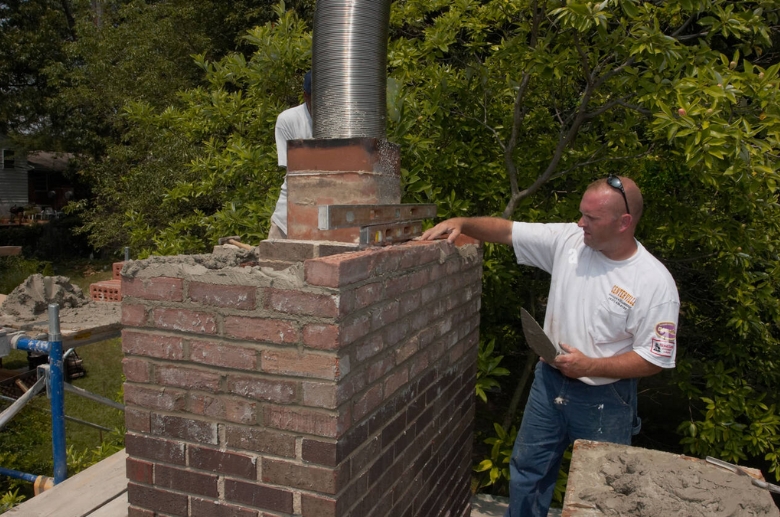 A technician installing a right sized chimney liner.