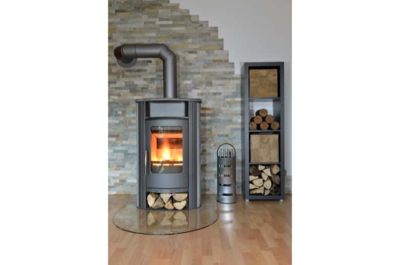 A freestanding woodstove with visible vent.