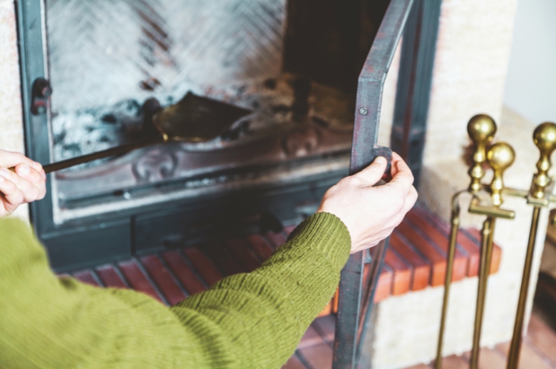 A man inspecting a fireplace.