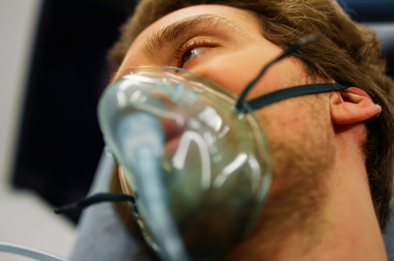 A man wearing an oxygen mask.