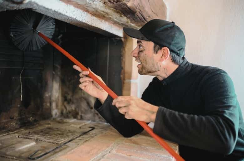 A technician cleaning the chimney flue.