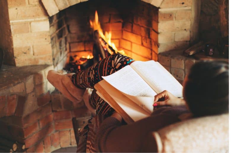 woman reading a book about how to check fireplace