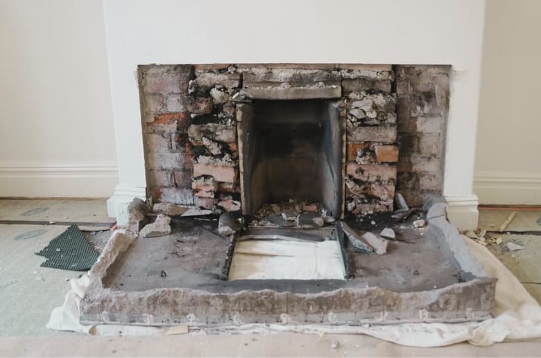 A demolished brick fireplace. The cost of Removing a Fireplace From Middle of House should be considered.