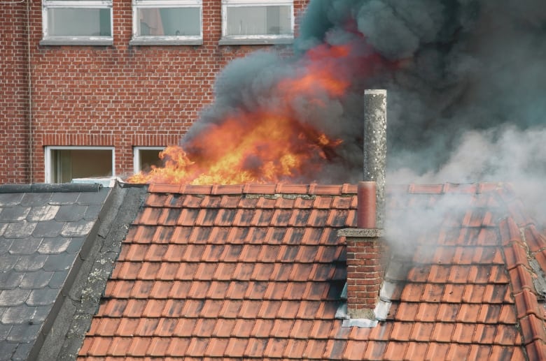 A roof on fire can be caused by a leaning chimney.