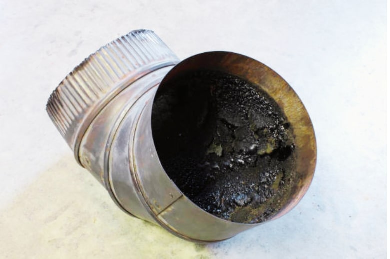 Creosote inside a pipe. Why Does My Chimney Keep Getting Clogged? Find out more.