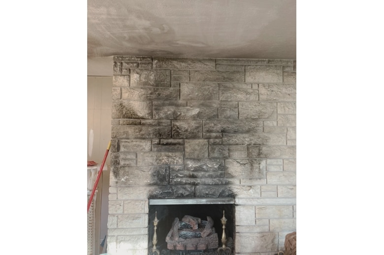Limestone fireplace with soot.