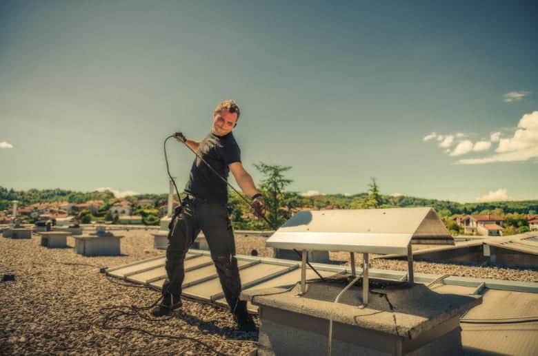 A technician cleaning a modern chimney.