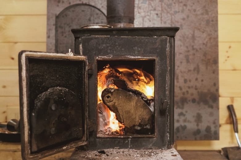 A non-catalytic wood stove with logs.