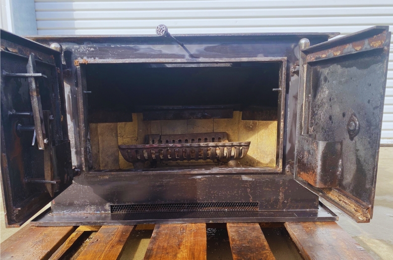 A rusted prefabricated fireplace.