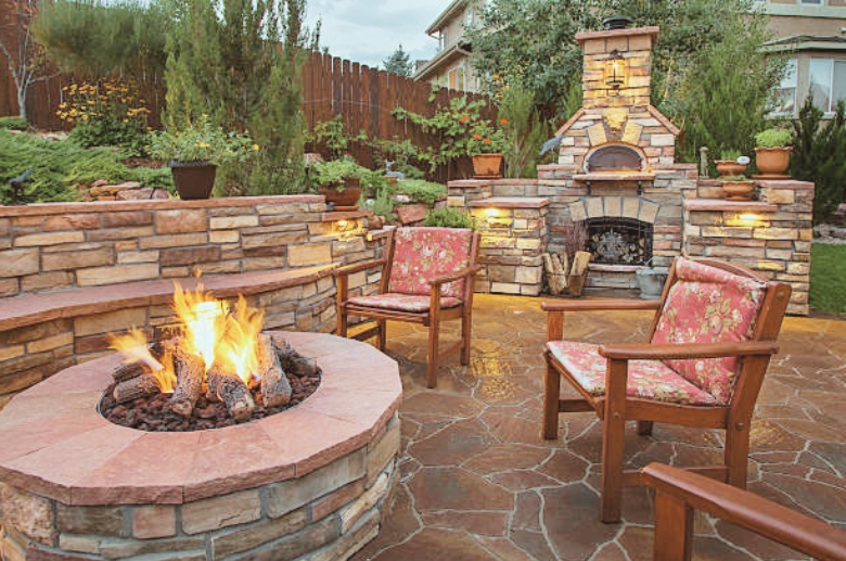 An expensive looking outdoor fireplace area.