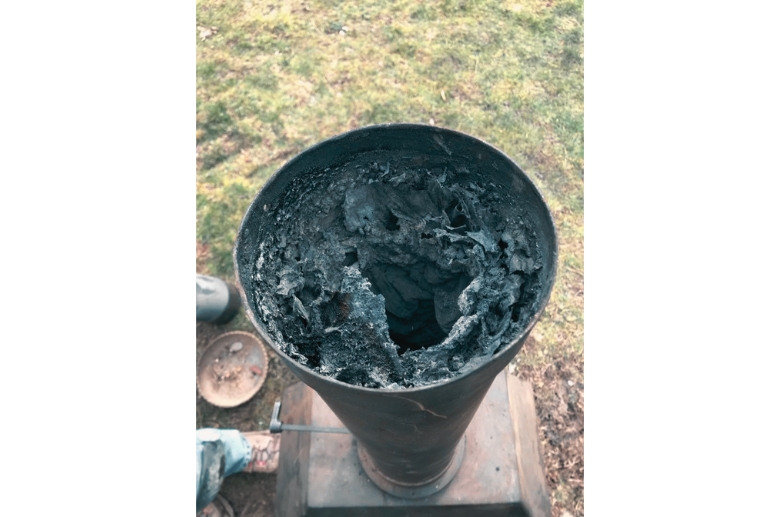 A blocked chimney flue with excessive creosote.