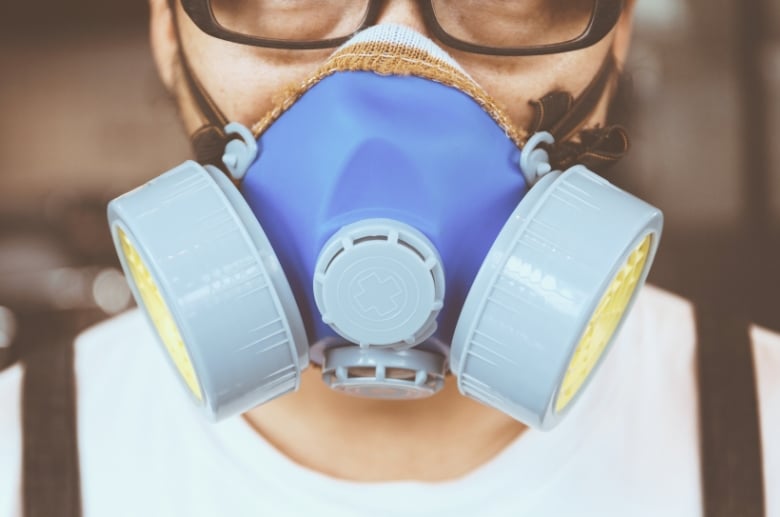 A man with a respirator mask and goggles.