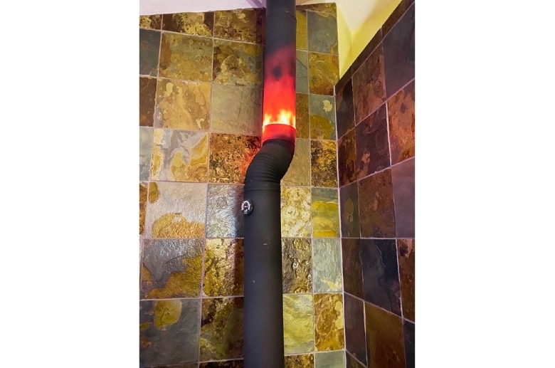 A furnace fire in a gas furnace flue.